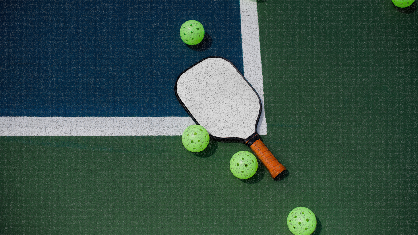 Pickleball paddle and balls on court